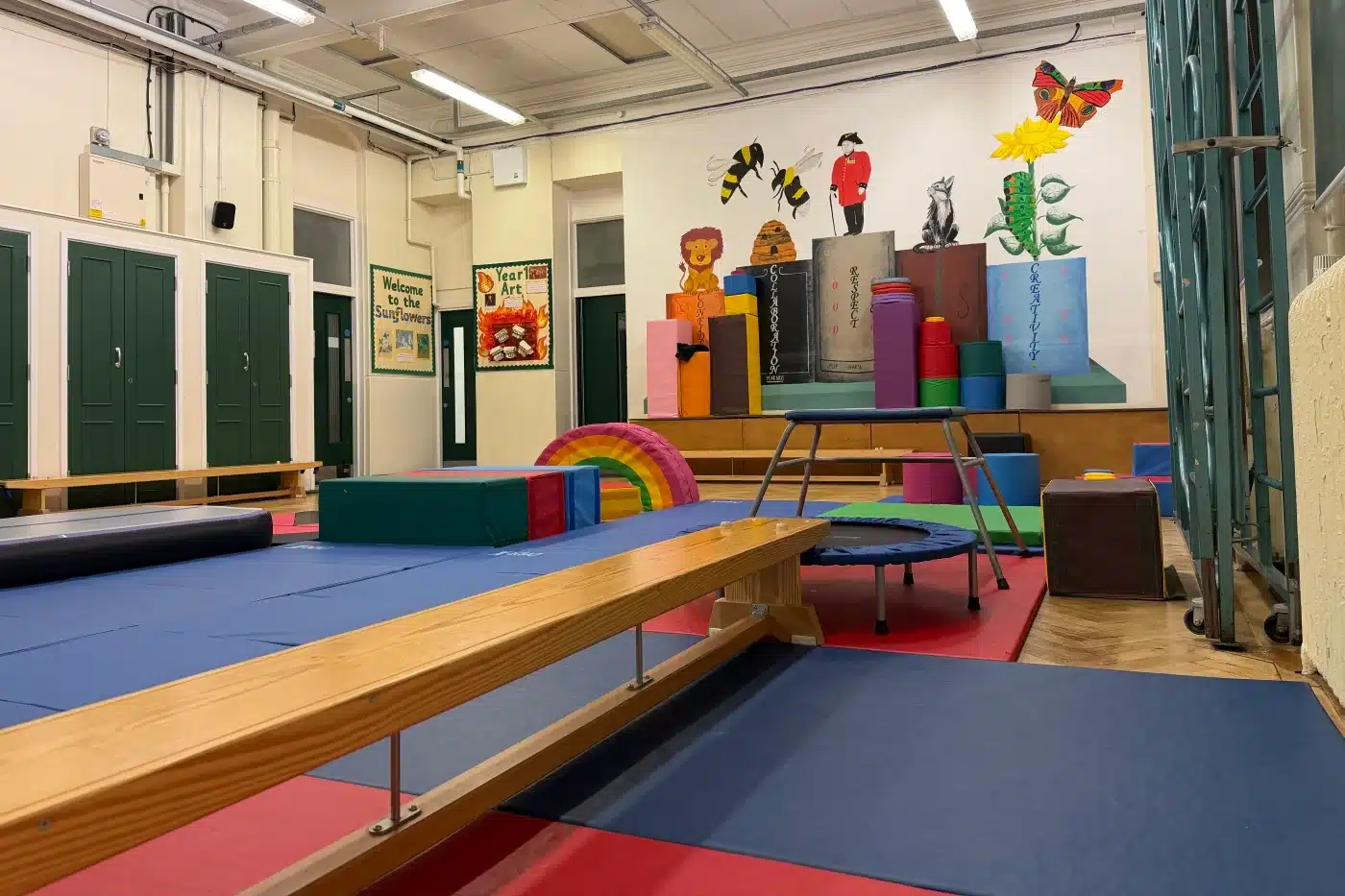 Spacious indoor hall at Park Walk School in Chelsea set up for children’s gymnastics classes with mats and balance equipment