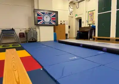 Children’s gymnastics training space at Park Walk School near King’s Road in Chelsea with KCGA equipment and mats