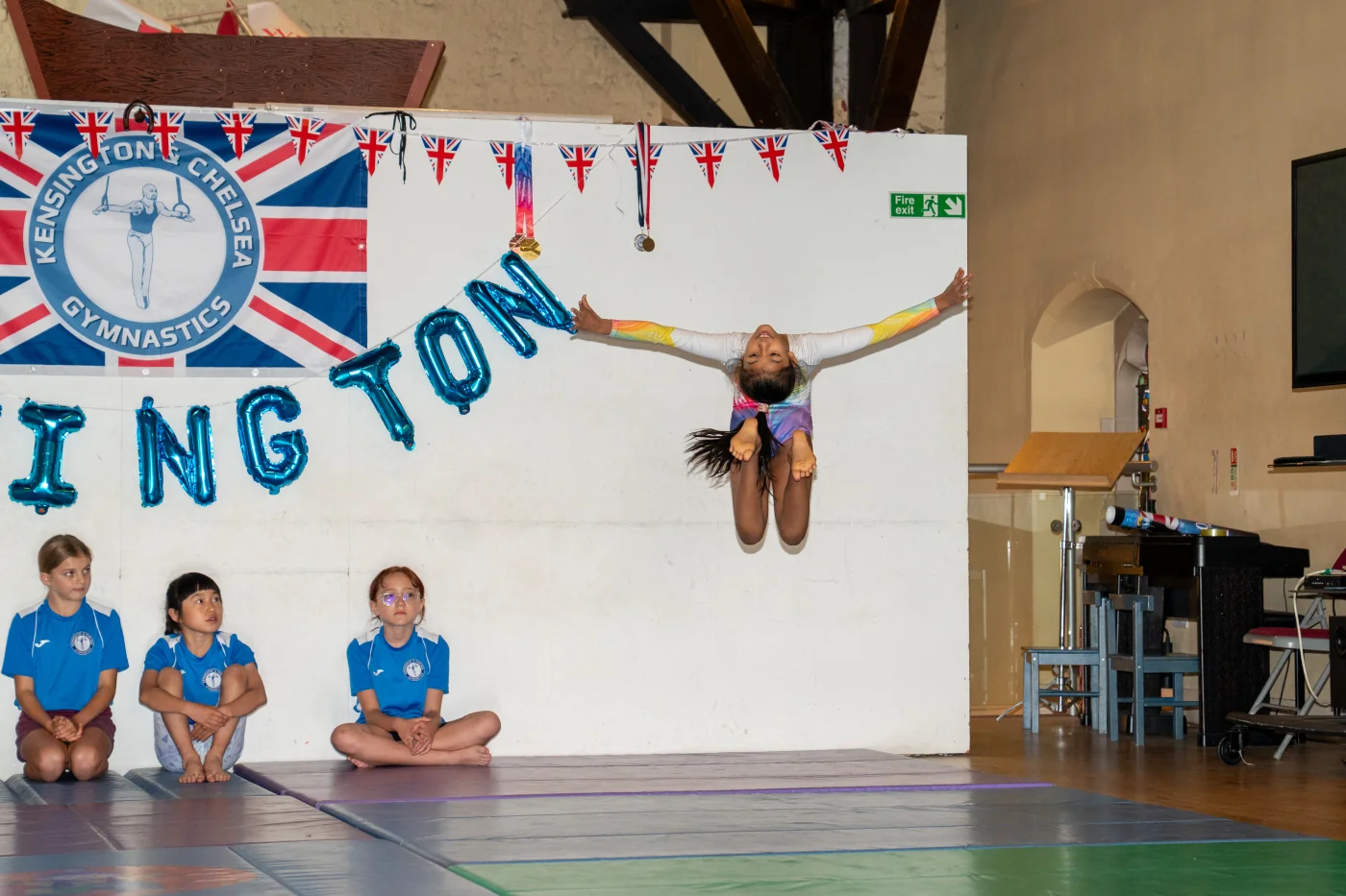 Indian gymnast Akshainie executes an advanced ring jump during her floor routine at Kensington & Chelsea Gymnastics Academy in London