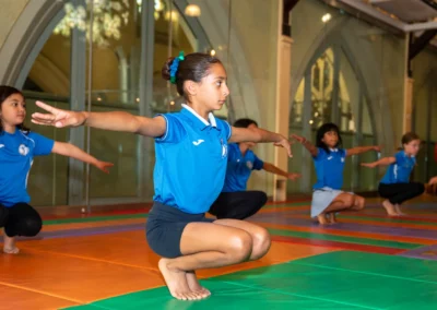Child performing balance squat exercise during KCGA Annual Performance 2025 in Kensington London
