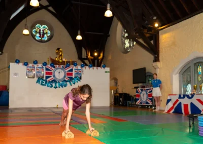 Strong female gymnast showing front support on mini bars in Kensington