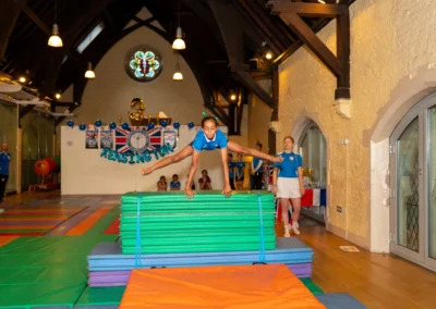 Gymnast performing straddle over on vault at KCGA Annual Performance London