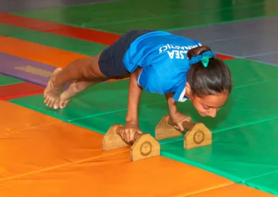 Child demonstrating core strength hold elbow planche at Kensington gymnastics annual performance