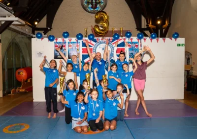 Children celebrating with medals and trophies at KCGA 2025 Annual Performance in Kensington London