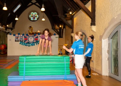 Child preparing for vault jump at London gymnastics club performance