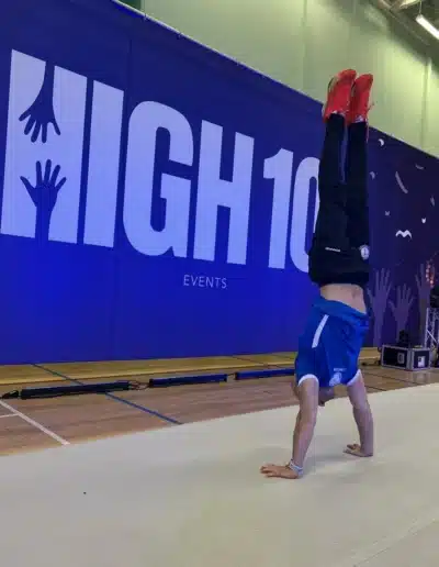 Dr Stefan Kolimechkov performing a handstand during a break at the 2025 Essex Invitational.