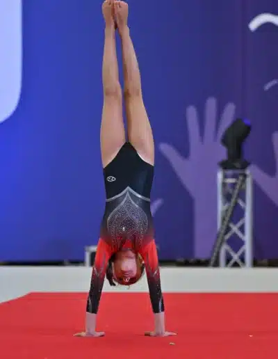 KCGA gymnast of the year 2025 Jasmine performing a handstand during her floor routine at the 2025 Essex Invitational.