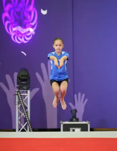 KCGA gymnast performing a jump during her floor routine at the 2025 Essex Invitational.