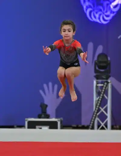 KCGA gymnast performing a floor jump at the 2025 Essex Invitational.