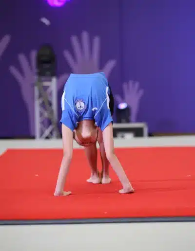 KCGA gymnast performing perfect bridge on floor at the 2025 Essex Invitational by High 10 Gymnastics Events.