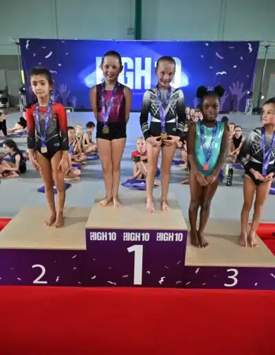 KCGA gymnast on the podium after winning Silver on Vault at the 2025 Essex Invitational.