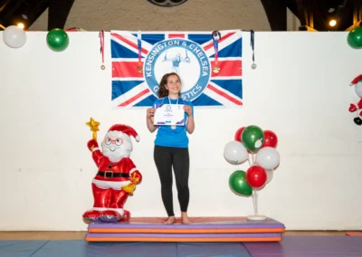Female Adult gymnast holding certificate at Chelsea Gymnastics adult class Christmas event in London.