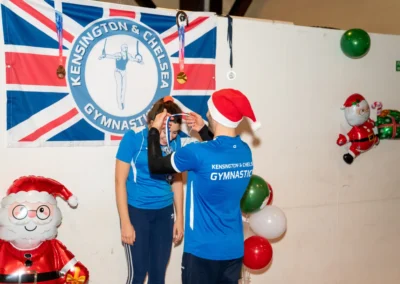 Adult gymnast receiving medal during Chelsea Gymnastics Christmas event in London.