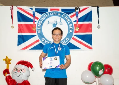 Adult gymnast receiving a medal during the Christmas adult gymnastics event at Kensington Gymnastics Academy in London W8.