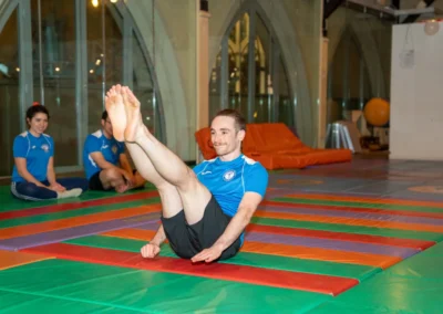 Adult gymnast holding a V-sit position during an adult gymnastics class in Kensington London W8.