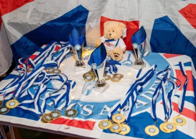 Medals and awards prepared for children at the KCGA Christmas 2024 event at Kensington Gymnastics Academy