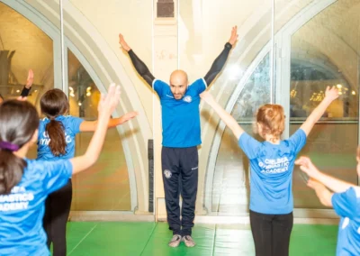 Gymnastics coach leading children during the KCGA Christmas 2024 event at Kensington Gymnastics Club