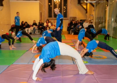 Children performing bridge exercises during the KCGA Christmas 2024 event at Kensington Gymnastics Club