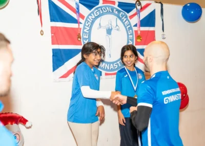 Children holding certificates and medals at Kensington Gymnastics Club