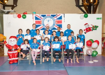 Children sitting together during gymnastics class at Kensington Gymnastics Academy