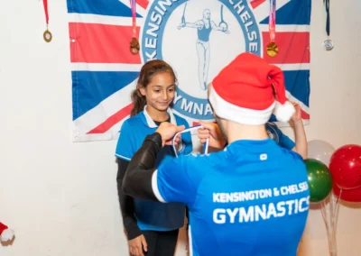 Children receiving medals at Kensington Gymnastics Club Christmas event