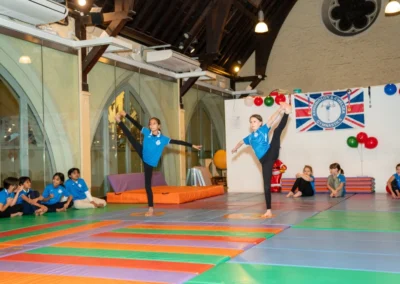 Child performing a balance exercise during the KCGA Christmas 2024 gymnastics event at Kensington Gymnastics Club
