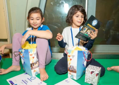 Children smiling at gymnastics Christmas event in Kensington