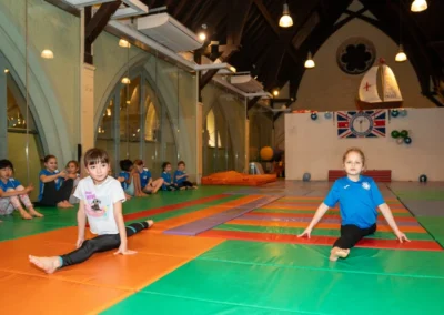 Children performing advanced split positions at KCGA gymnastics club London Christmas event