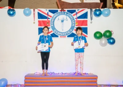 Children on awards podium at KCGA Christmas gymnastics event in Kensington London