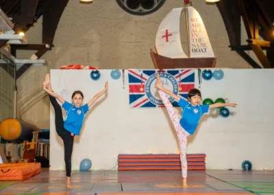 Child performing Y balance pose at KCGA Christmas gymnastics showcase in Kensington London