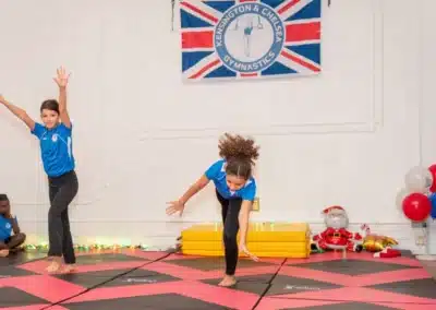 Young gymnasts performing floor exercises during Knightsbridge Gymnastics class at More House School