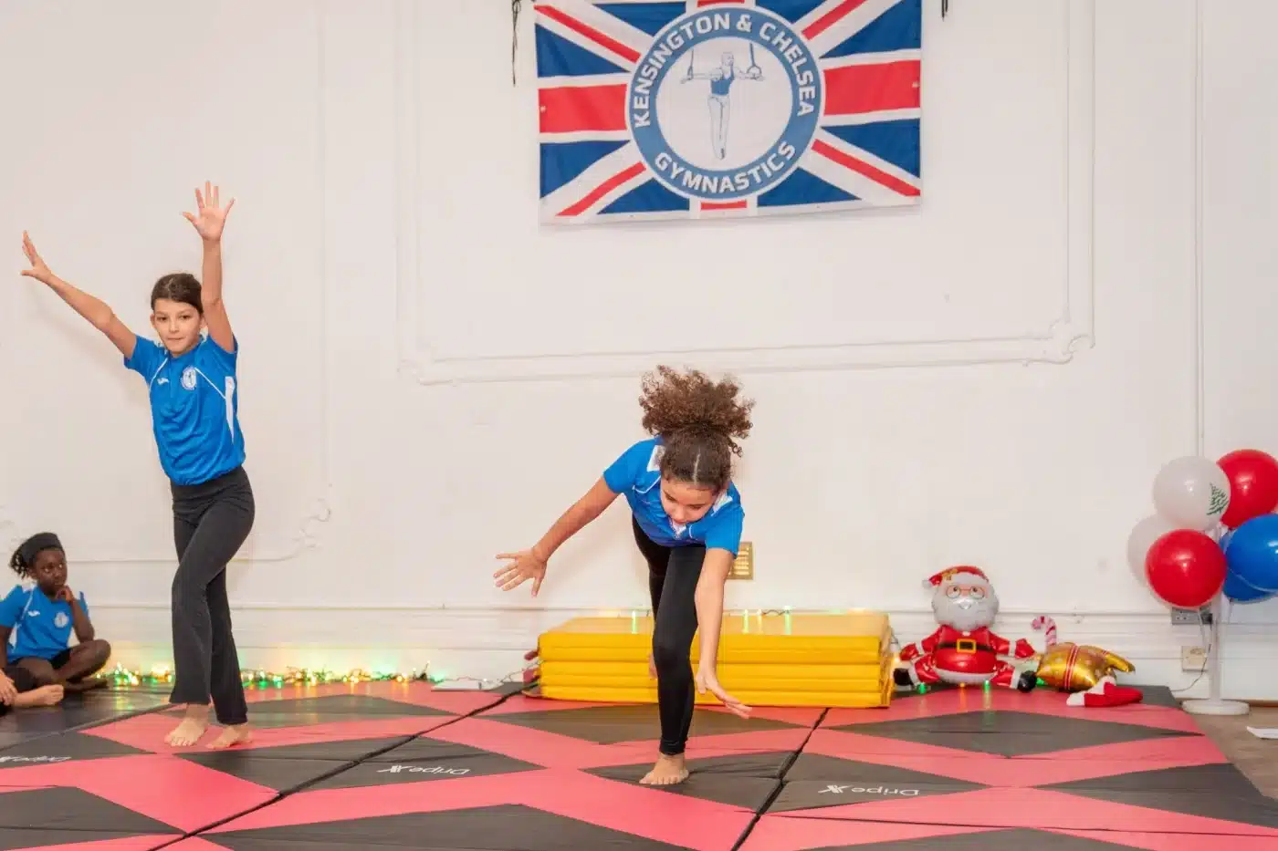 Young gymnasts performing floor exercises during Knightsbridge Gymnastics class at More House School