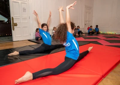 Young gymnast performing cross split during gymnastics class in Knightsbridge London SW1X