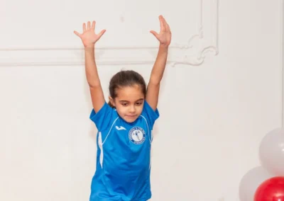 Young gymnast presenting finishing pose in Knightsbridge gymnastics class at More House School