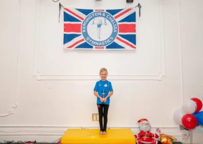 Child holding trophy at Knightsbridge Gymnastics Christmas 2024 event at More House School SW1X London