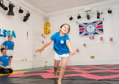 Young gymnast transitioning from floor skill at KCGA Annual Performance Knightsbridge London