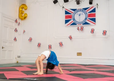 Young gymnast performing a bridge at KCGA Annual Performance More House School Knightsbridge SW1X
