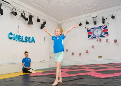 Young gymnast holding finishing pose at KCGA Annual Performance More House School Knightsbridge