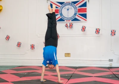 Young gymnast performing straight handstand at KCGA Annual Performance More House School Knightsbridge London SW1X
