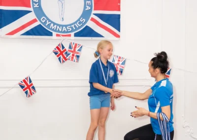 Young gymnast receiving medal at KCGA Annual Performance More House School Knightsbridge London