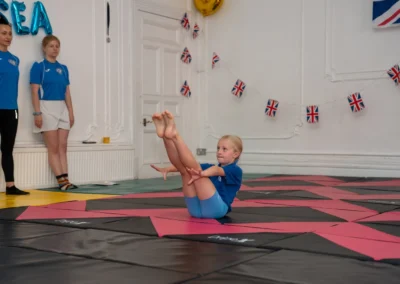 Child performing V-sit gymnastics move at More House School Knightsbridge London