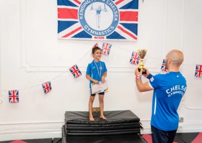 Coach presenting KCGA Gymnast of the Year trophy to Knightsbridge gymnast at More House School London SW1X