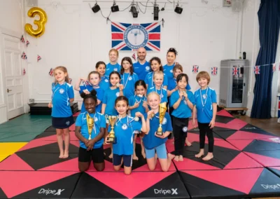 Knightsbridge gymnastics team with coaches at KCGA Annual Performance 2025 in London