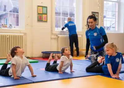 Children practising beginner floor exercises during a KCGA gymnastics class in Chelsea