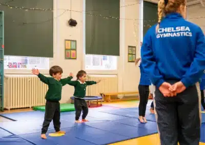 Young children taking part in a KCGA pre-school gymnastics warm-up class in Chelsea