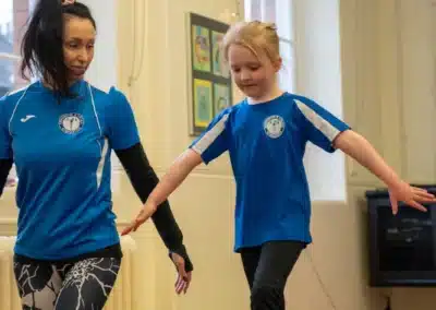 Young girl practising the hurdle step for vault during pre-school gymnastics classes in Chelsea
