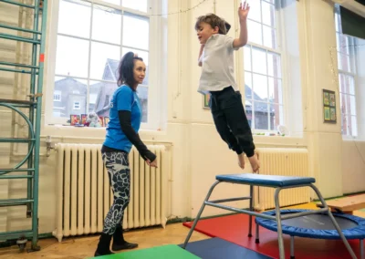 Young boy performing a straight jump from the vault platform during a KCGA Chelsea gymnastics class