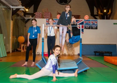 Group of young gymnasts posing around the bars during an Easter gymnastics session in Kensington London