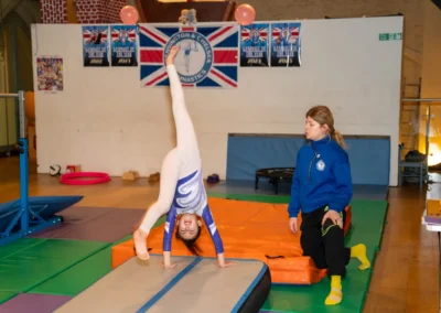 Gymnast performing a handspring on an air track during gymnastics training in Kensington London