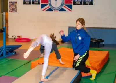 Young gymnast performing the hurdle step before a handspring on an air track during gymnastics training in Kensington London